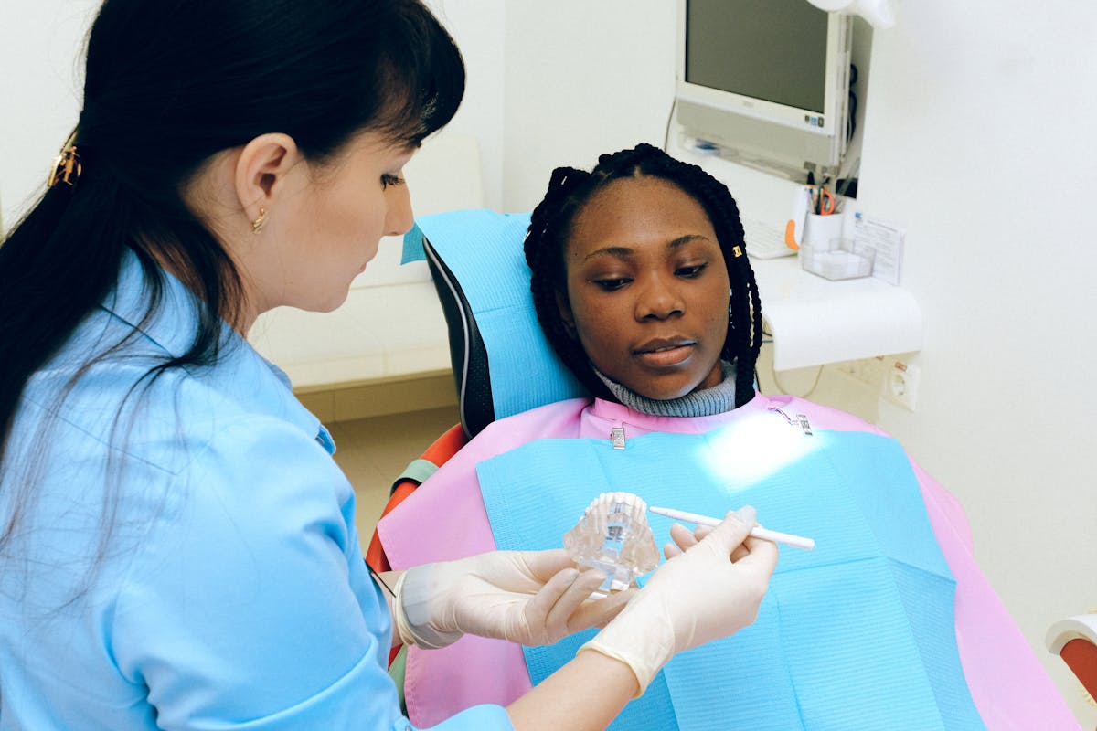 Dentist explaining All-on-X treatment using a jaw model